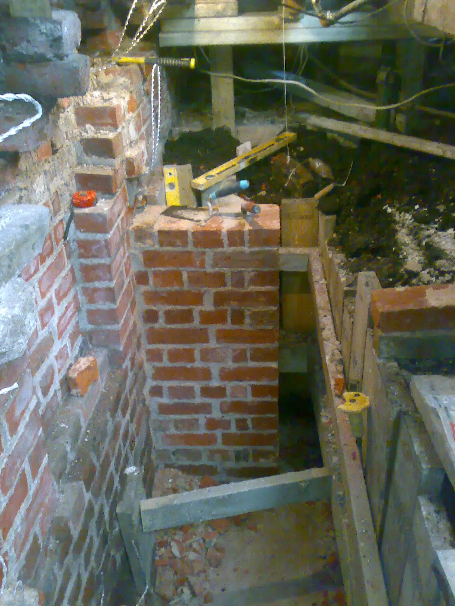 New footings and lime mortar brickwork in basement.