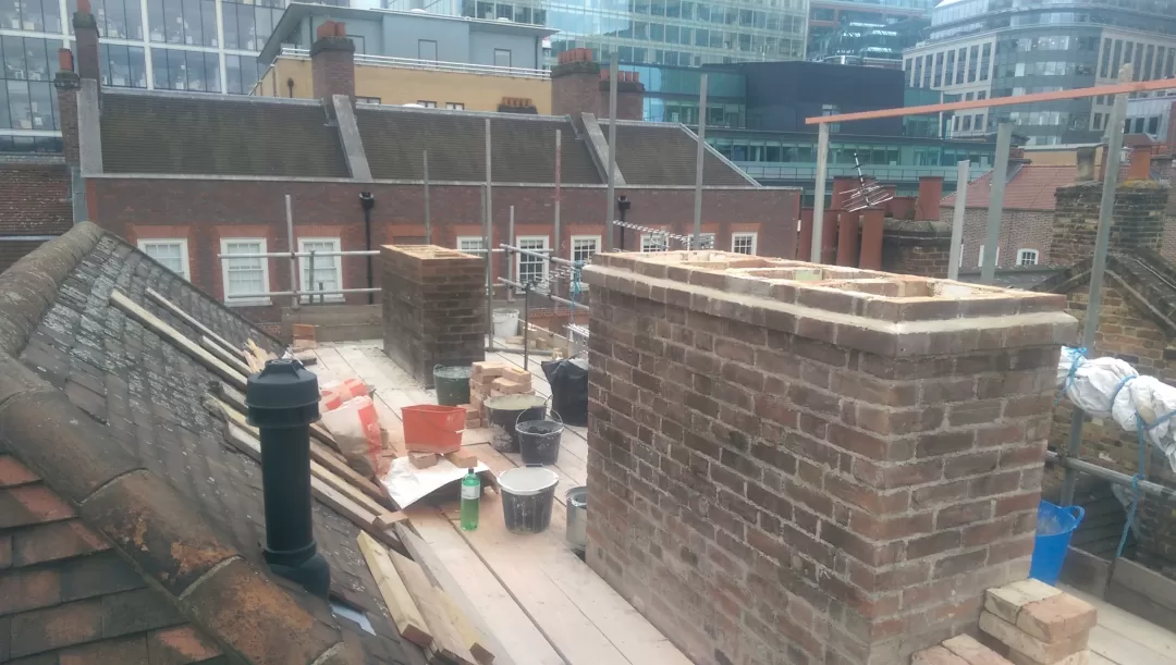 Chimneys being rebuilt with lime mortar.