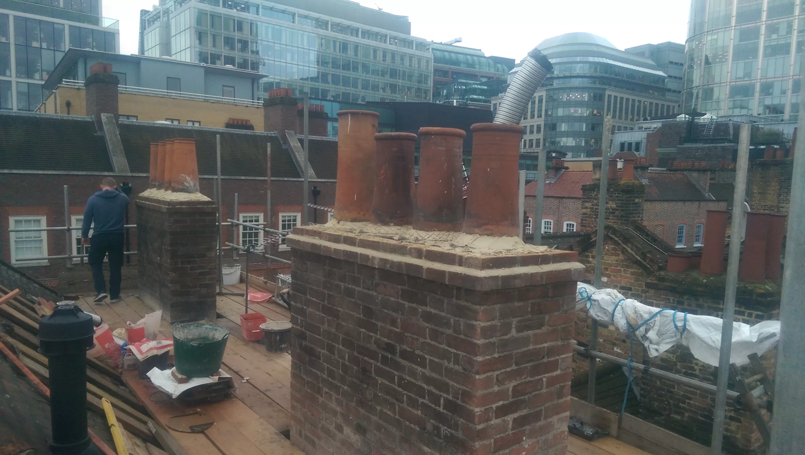 Chimney brickwork complete and chimney pots set in lime mortar.