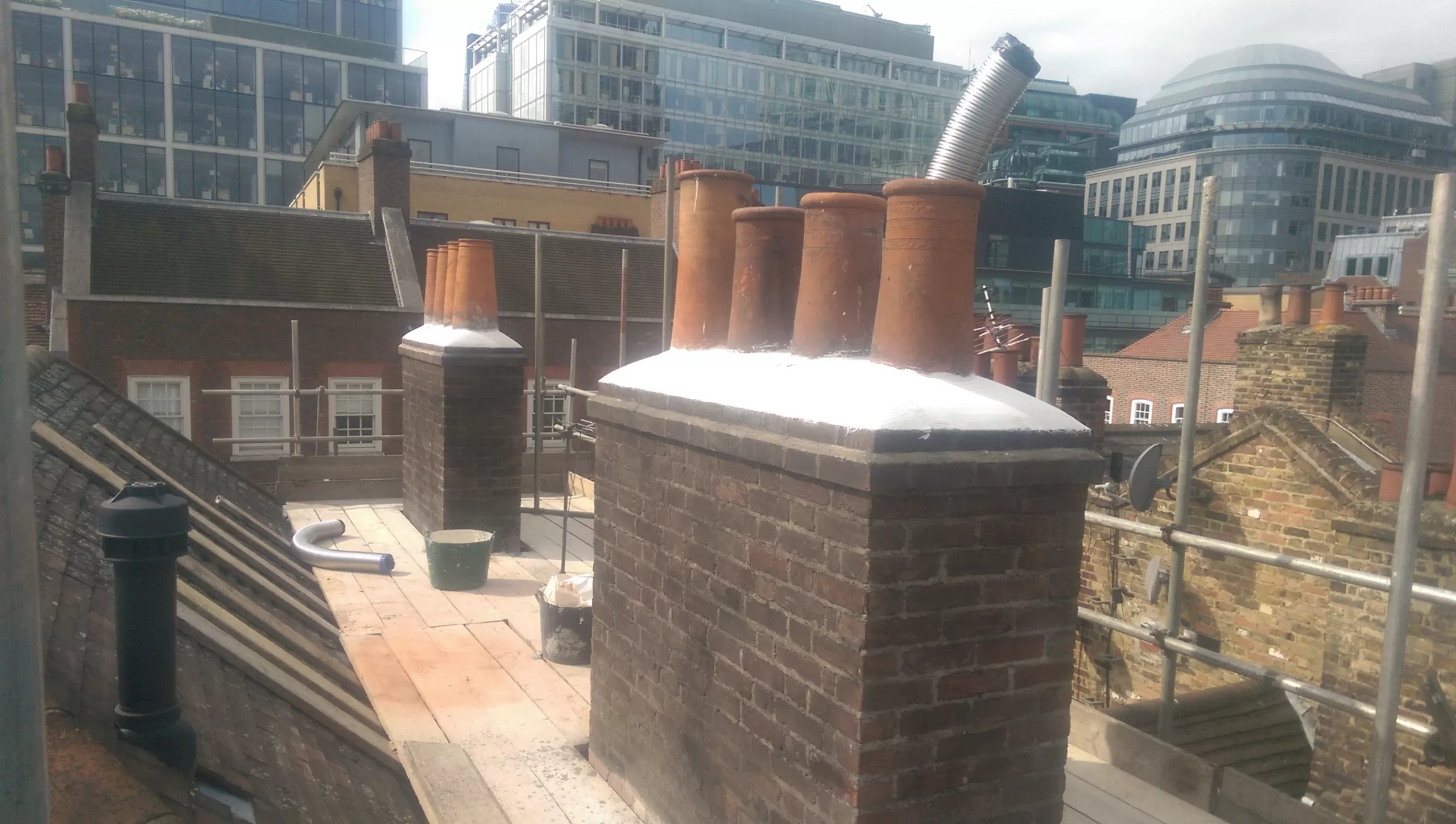 Chimneys with pots and lime mortar flaunching.