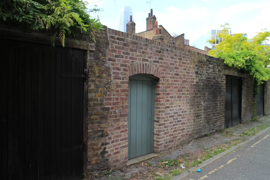 Lime mortar brick wall with gate.