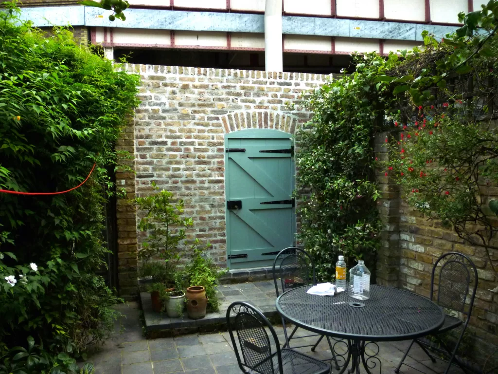 Gate and lime mortar red brick wall