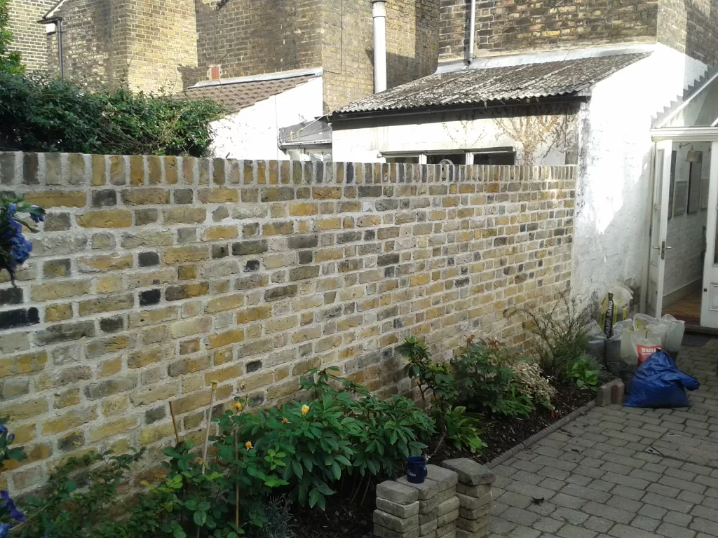 Yellow stocks wall built with lime mortar.