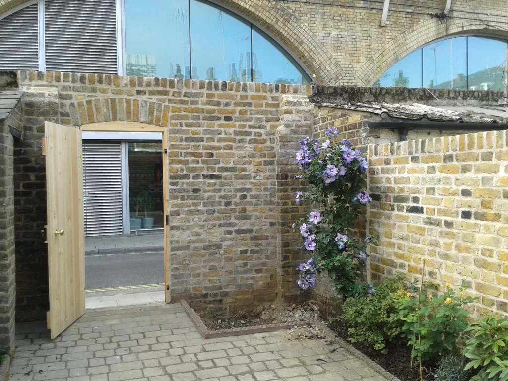  Yellow stock garden wall with gate.